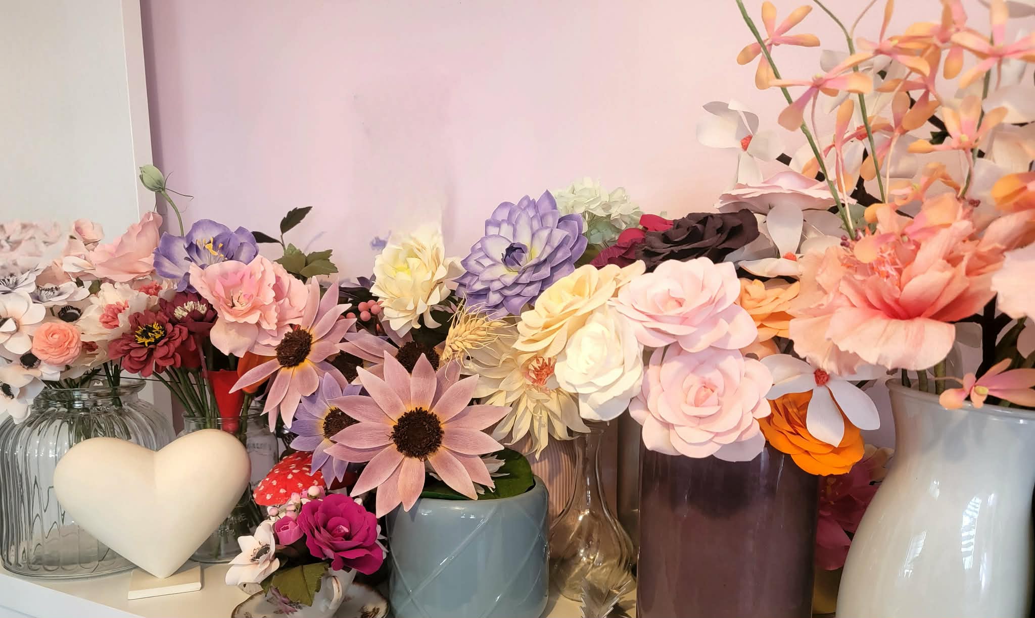 A shelf of Miranda's handcrafted paper flower arrangements