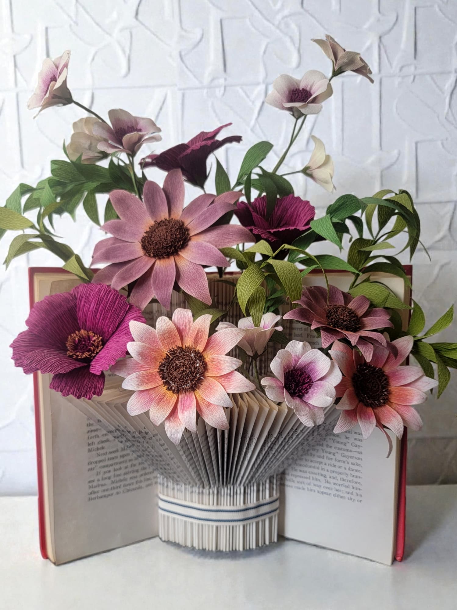 Open book folded into a vase of paper flowers