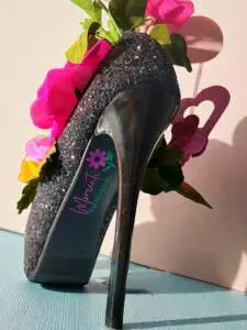 The underside of a stiletto shoe with the Momenti by Miranda logo