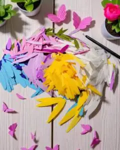 Brightly coloured flower petals cut out of crepe paper.